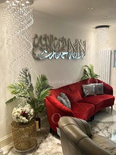 a living room with red couches and chandelier hanging from the ceiling above