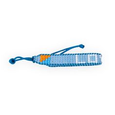 a beaded bracelet with an orange and white cross on the end, blue cord