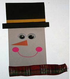 a paper bag with a snowman on it and a scarf hanging from the side