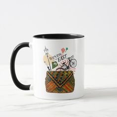 a black and white coffee mug with an image of a basket on the front, which says winds east