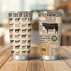 two tumblers with different types of cattle on them sitting on top of a wooden table