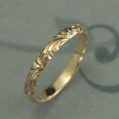 a gold wedding ring with filigrees on it