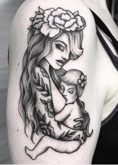 a woman holding a baby in her arms with flowers on her head and the word mom written