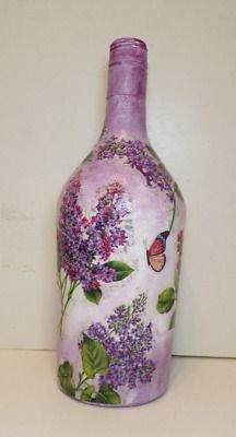 a purple vase sitting on top of a white counter next to a wall with butterflies and flowers painted on it