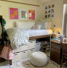 a bedroom with a bed, desk and storage drawers on the bottom shelf in front of it