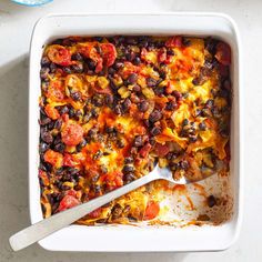 a casserole dish with black beans and tomatoes