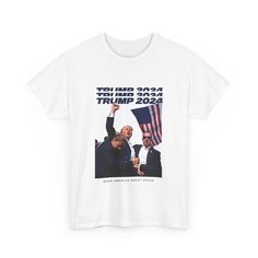 a white t - shirt with the image of two men holding an american flag in front of them