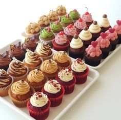 there are many different cupcakes on the tray