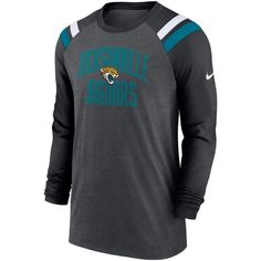 The Men's Nike Heathered Charcoal/Black Jacksonville Jaguars Tri-Blend Raglan Athletic Long Sleeve Fashion T-Shirt is the perfect way to show unwavering support for the Jacksonville Jaguars. With its comfortable cotton, polyester, and rayon blend, this long sleeve tee is perfect for any occasion. Raglan sleeves and sewn-on stripes add a touch of style, while screen print graphics proudly display Jacksonville Jaguars pride. Whether cheering from the stands or hanging out, this t-shirt is sure to Nike Mens Clothing, Athletic Long Sleeve, Long Sleeve Fashion, Fashion T Shirt, Sleeve Fashion, Jacksonville Jaguars, Charcoal Black, Athletic Fashion, Black Charcoal