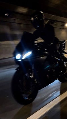 a person riding a motorcycle in the dark