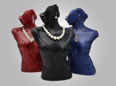 three female mannequins with pearls on each one's neck and necklace