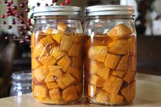 two jars filled with food sitting on top of a table