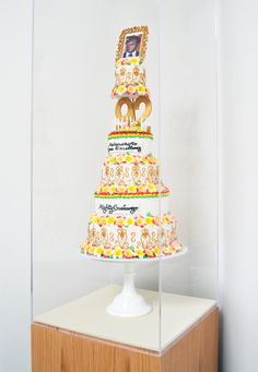 a three tiered cake on display in a glass case