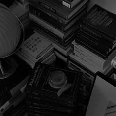 a stack of books sitting next to a lamp