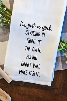 a tea towel that says i'm just a girl standing in front of the oven