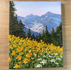 a painting of mountains and flowers in the foreground with pine trees on either side