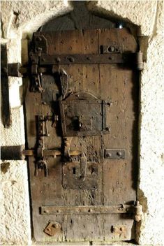 an old wooden door with metal latches on it