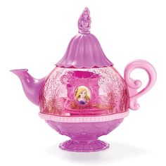 a pink tea pot with a princess figure on it