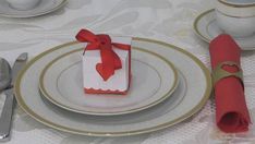 a table set with plates, silverware and napkins for a holiday dinner or special occasion