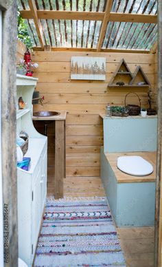 a small bathroom with wooden walls and flooring