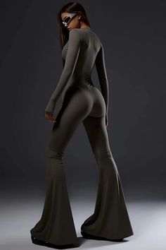 Step into elegance with our Dark Grey Bell Bottom Jumpsuit. Combining style and comfort, the Turtleneck, coupled with Long Sleeves, offers sophistication. The Bodycon Fit ensures a sleek silhouette. With an Invisible Front Zipper Closure for ease, the Stretchy Fabric guarantees comfort. Make a statement in this chic and versatile piece that seamlessly blends fashion and flair. Features & Details Women's Jumpsuit Dark Grey Bell Bottom Turtleneck Long Sleeves Bodycon Fit Invisible Front Zipper Closure Stretchy Fabric Fabric & Care Care Instructions: Hand wash at 30°. Do not Bleach. Do not iron. Cold dry only. Composition: 100% Polyester Size & Fit The model is wearing size S Jumpsuit runs small Stretchy fabric Sleek Stretch Solid Jumpsuits And Rompers, Sleek Stretch Long Sleeve Jumpsuits And Rompers, Fitted Full Length Solid Color Bodysuit, Sleek High Stretch Jumpsuits And Rompers, Chic Fitted Full Length Bodysuit, Chic Fitted Full-length Bodysuit, Fitted Full Length Solid Jumpsuits And Rompers, Fitted Full-length Solid Jumpsuits And Rompers, Fitted Full Length Bodysuit For Loungewear