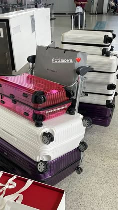 several pieces of luggage sitting on top of each other in front of an airport checkout counter