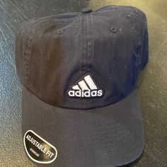 This Cap Comes New, With The Tags Still Intact, And Has Never Been Worn Before. This Is A Men’s Adidas Adjustable Fit Cap And The Body Is 100% Cotton. This Is Mostly Black With The White Adidas Lettering And Symbol On The Front And Back Of The Cap. This Hat Sells In Stores For A Retail Price Of $24. Adidas Casual Hat For Sports Events, Casual Adidas Hat For Sports Events, Casual Adidas Baseball Cap For Sports Events, Adidas Flat Bill Hat For Streetwear, Casual Sports Hat With Adjustable Fit, Adjustable Adidas Cotton Hat, Casual Adjustable Dad Hat For Sports, Adidas Adjustable Baseball Cap, Adidas Adjustable Baseball Cap For Sports Events