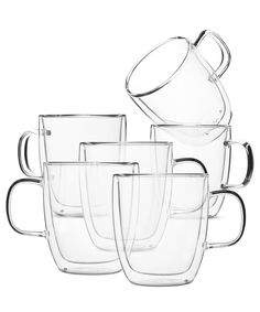 a stack of glass cups with lids and handles