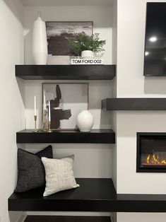 a room with some shelves and a fire place