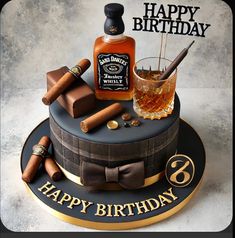 a birthday cake with an image of a bottle of whiskey and cigars on it