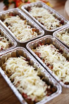 six trays filled with food sitting on top of a table