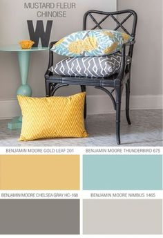 a chair with yellow and blue pillows in front of it, next to a shelf