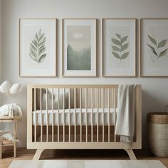 a baby's room with three framed pictures on the wall and a crib