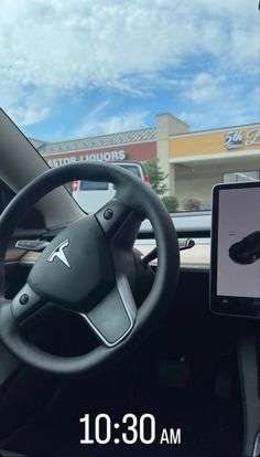 the dashboard of a car with an electronic device in front of it