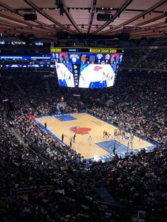 a basketball game is being played in an arena