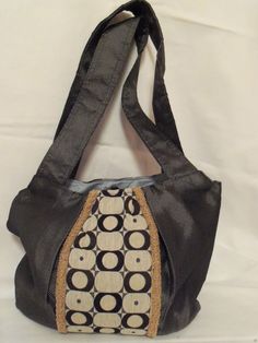 "One of a kind hobo, shoulder handbags have an upholstery grade fabric exterior with a 100% cotton fabric interior.  Purses are approximately 13\"W x 12\"H with 14\"H strap(s). This listing is for ONE purse - please make your selection from the drop down menu. Photo 1: Circles  Photo 2: Black Photo 3: Camel Circles purse has a silver/gray exterior accented with multi size and multi colored circles fabric in the center of the purse.  The circle fabric has a beige background with black, gray and dirty gold circles.  Center panel is flanked by curly gold gimp to coordinate with the dirty gold circles on the center panel fabric.   Purse has a light blue 100% cotton fabric interior; three pockets; one which is a zipper pocket.  Has (2) 14\"H straps and a magnetic closure. Black purse is made fr Elegant Everyday Shoulder Bag In Fabric, Elegant Everyday Fabric Shoulder Bag, Chic Fabric Shoulder Bag For Travel, Fabric Shoulder Bag With Adjustable Strap For Shopping, Evening Hobo Shoulder Bag With Zipper Pocket, Fabric Satchel Bag For Shopping, Fabric Shoulder Bag With Zipper Pocket For Daily Use, Fabric Shoulder Bag For Shopping, Everyday Tote Bag With Fabric Lining