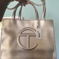 Nwt Telfar Medium Shopping Bag In The Color Gold. Original Packaging And Dust Bag Included. Height 11 1/4", Width 15", Depth 5", Strap Drop 21", Handle Drop 5 1/2" Reasonable Offers Accepted Gold Bags With Branded Hardware And Double Handle, Luxury Gold Bag For Errands, Gold Bag With Branded Hardware For Everyday, Gold Bag With Top Carry Handle For Errands, Gold Shoulder Bag With Branded Hardware For Shopping, Gold Top Handle Bag For Errands, Designer Gold Shoulder Bag For Errands, Luxury Gold Shoulder Bag For Errands, Designer Gold Double Handle Bag