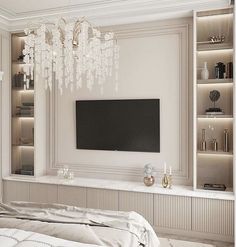 a white bedroom with chandelier hanging from the ceiling and television in the corner