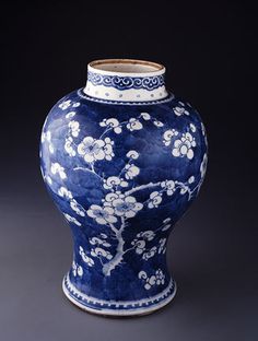 a blue and white vase sitting on top of a table