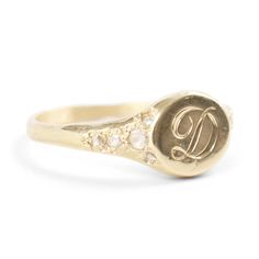 Viola's Treasure possesses the spirit of a well-worn pinkie ring, inherited by the favorite daughter of a dashing patriarch who once scaled Kilimanjaro and showed Hemingway the ways of Paris. Made to be handed down through the generations. Gorgeously hand-engraved with a single initial.�See Details for item specifics.Financing options available in partnership with�Affirm. Fine Jewelry Yellow Gold Signet Ring With Diamond Accents, Yellow Gold Signet Ring With Diamond Accents, Luxury Yellow Gold Signet Ring With Single Cut Diamonds, Heirloom Gold Engraved Ring With Diamond Accents, Timeless Gold Engraved Ring With Diamond Accents, Timeless Engraved 14k Gold Ring With Diamond Accents, Heirloom Gold Diamond Signet Ring, Gold Diamond Heirloom Signet Ring, Luxury Signet Ring With Rose Cut Diamonds