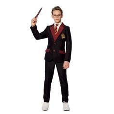 a young man in a harry potter costume holding a wand and pointing to the side