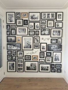 a wall with many pictures on it and some framed photos hanging up against the wall