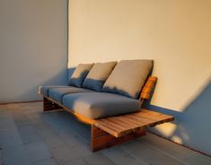 a couch sitting on top of a wooden bench