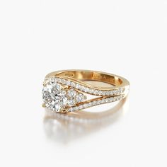 a yellow gold engagement ring with two diamonds on the band and an oval cut diamond in the center