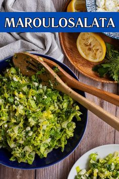 A blue bowl with maroulosalata (greek lettuce salad) sits on a wooden table. There are two wooden spoon sitting in the bowl. A small white plate with some salad is in the bottom right corner. A wooden plate with a squeezed lemon, some fresh parsley and dill and a blue bowl with feta cheese is in the top right. There is a grey cloth in the top left. Vegetarian Salads