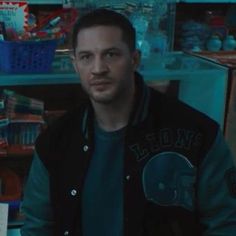 a man standing in front of a shelf filled with toys