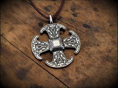 The Canterbury cross, an 8th century Anglo-Saxon brooch, reproduced here as a pendant in lead free pewter or sterling silver. Hand cast, detailed and polished to a silver shine. Measures 4.5cm × 4cm and includes a 1 meter leather cord. Medieval Silver Cross Pendant Jewelry, Medieval Engraved Cross Pendant Jewelry, Medieval Engraved Cross Jewelry, Hand Forged Silver Viking Jewelry, Medieval Silver Cross Jewelry, Byzantine Silver Necklace With Cross Pendant, Silver Byzantine Necklace With Cross Pendant, Medieval Silver Cross Necklace, Silver Cross Necklace With Antique Finish