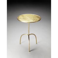 a gold table with two legs and a small round tray on the top that has holes in it