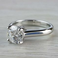 a white gold engagement ring with a round cut diamond