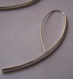 "Beautiful simple contemporary earrings of minimal design that will look great with a casual outfit, as well as a more formal one. I formed a 2 mm. sterling silver wire to a graceful curve and soldered a .7 mm. ear wire for a simple, minimalist, and fashionable look. I will include a pair of silicone backs for safety. Length: now you can pick your favorite length by clicking on the drop down bar under the price. Your choice of 2\" (as pictured above), 1 3/4\", or 1 1/2\" Ear wire: 21 Ga (0.7mm)" Simple Sterling Silver Threader Earrings For Everyday, Everyday Silver Hoop Earrings With French Hook, Modern Sterling Silver Linear Earrings With Ear Wire, Minimalist Sterling Silver Hoop Earrings, Sleek Sterling Silver Earrings For Everyday, Classic Silver Linear Earrings For Everyday, Sleek Everyday Sterling Silver Earrings, Modern Silver Threader Earrings With Ear Wire, Silver Minimalist Threader Earrings With Ear Wire